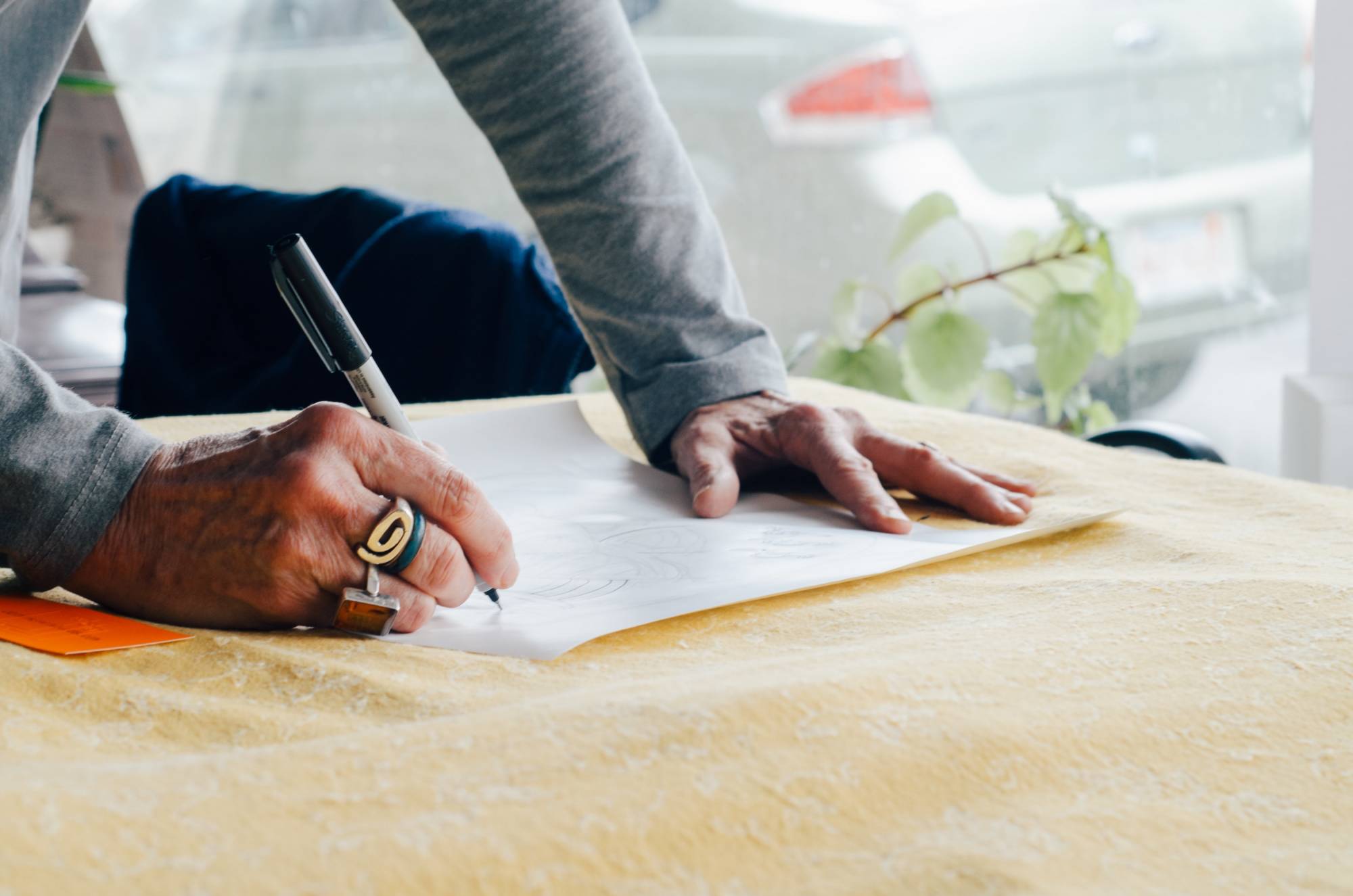 man writing on paper